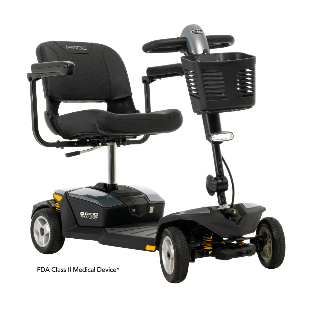 The Pride Mobility Go Go® Endurance Li 4-Wheel Scooter is a sleek black model featuring Comfort-Trac Suspension, a padded seat and backrest, sturdy steering handle, front basket, and is labeled FDA Class II Medical Device, all powered by a reliable lithium battery.